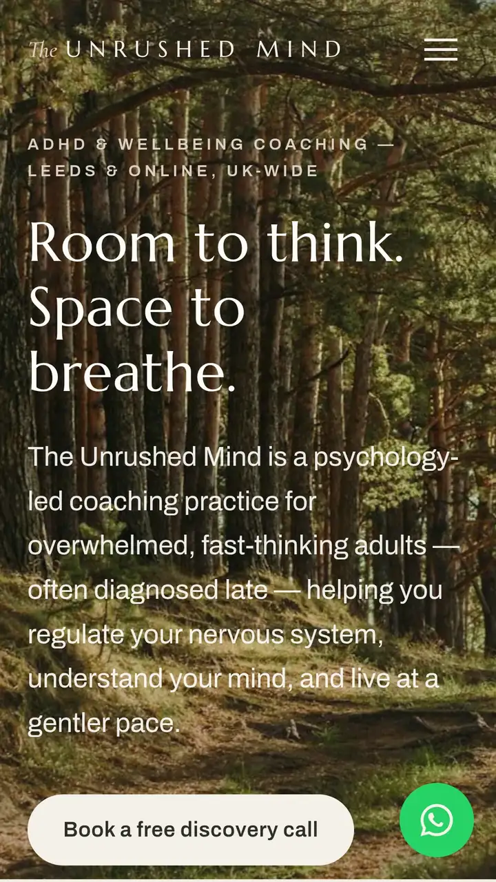 The Unrushed Mind homepage on a phone: forest photograph, “Room to think. Space to breathe.” headline, discovery-call button and WhatsApp bubble